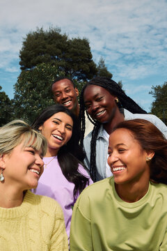 Diverse young adults smiling together outdoors