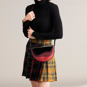 Chic Black Turtleneck With Plaid Skirt And Handbag