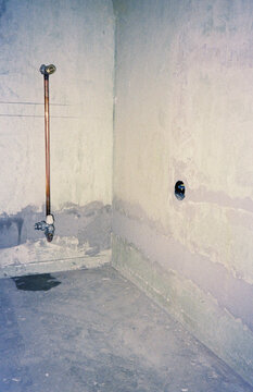 Analog Film Photograph of Radiator Pipe in Unfinished Interior