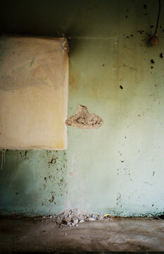 Damaged Wall with Plaster Patch and Exposed Hole