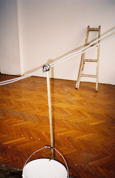Temporary Plumbing Pipe and Wooden Ladder on Parquet Floor