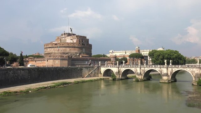 Ponte Sant Angelo spans Rome Italy, historic bridge linking riverfront and castle scenery.