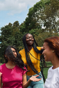 Diverse young women enjoying friendship and conversation outdoors