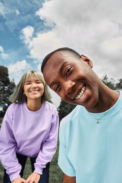 Happy diverse friends smiling outdoors on a bright day