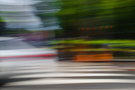 Motion Blur of Cars at a City Street Crossing During the Day