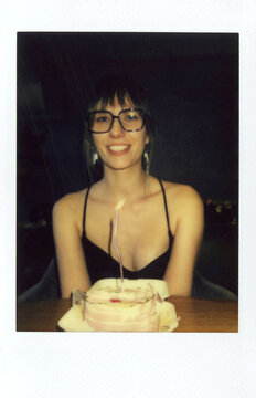Happy Girl with Birthday Cake and Candle Posing for Polaroid