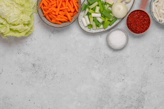Korean cooking frame, fresh vegetables and gochugaru for kimchi from above