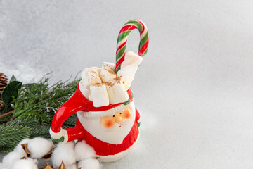 Santa mug with hot chocolate marshmallows and candy cane on a winter setting © ir1ska