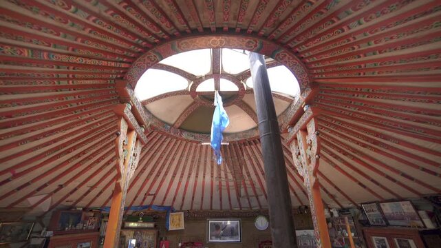 Mongolian ger detail shows carved rafters and ornaments, traditional yurt craftsmanship inside.
