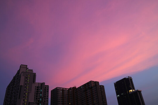 Dreamy vibrant purple pink and blue urban sunset sky