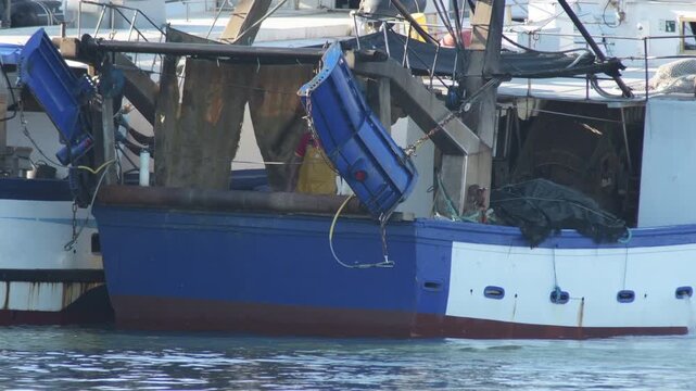 Commercial trawler fishing boat stern and blue otter boards