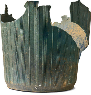 broken old plastic bucket isolated white background, dirty weathered dark green ribbed container with missing pieces, side view