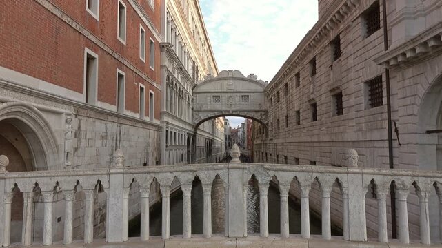 View of the historic Bridge of Sighs spanning a narrow canal between the Doge's Palace and the prison in Venice, Veneto, Italy.