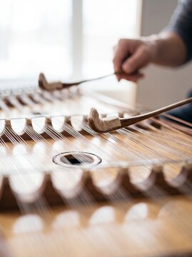East Asian Musician Playing Resonant Steel Dulcimer Strings