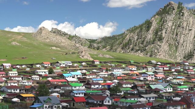 Tsetserleg Mongolia town with colorful roof houses and ger tents across a scenic valley.
