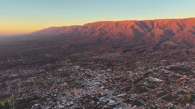 Wide angle aerial clip showing Merlo city urban grid and vast mountain landscape in San Luis