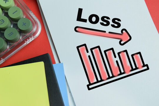 Concept of loss graph write on book isolated on table. For financial crisis and stock market decline