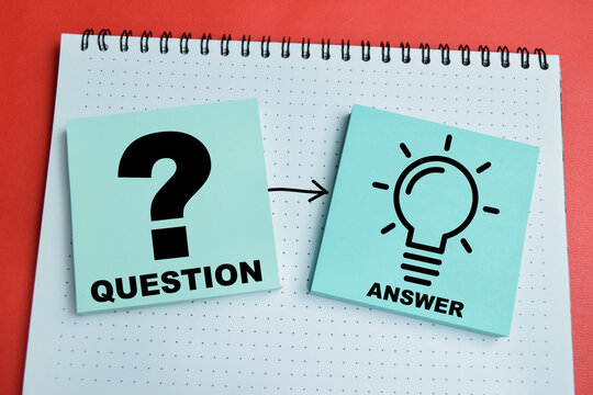Concept of question and answer write on sticky notes isolated on table. For creative ideas and solutions