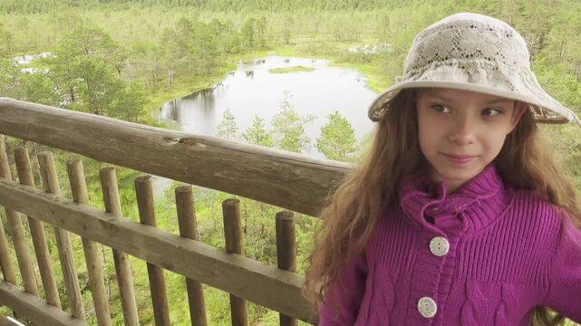 Little beautiful girl walks on swamp in Estonia