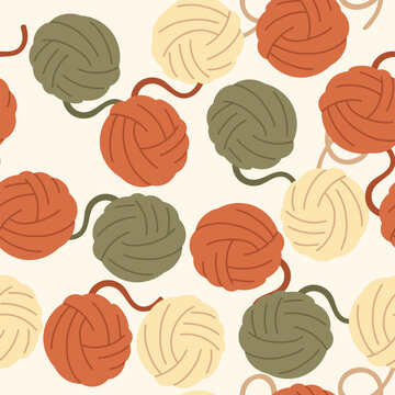 Vector seamless knitting pattern with colorful yarn balls in warm autumn colors. Cozy handicraft background for textile, fabric, DIY wrapping paper, wallpaper, packaging design, hand drawn hobby print