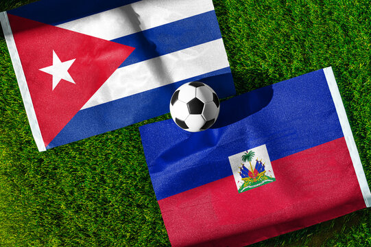 Cuba vs. Haiti football match. National flags on green grass with soccer ball in the middle. Football background for international match.