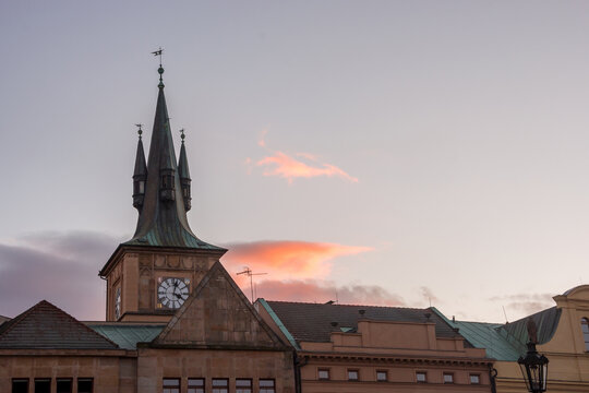 Old Town Water Tower near Charles Bridge against a sunset sky with pink clouds in Prague, Czech Republic.