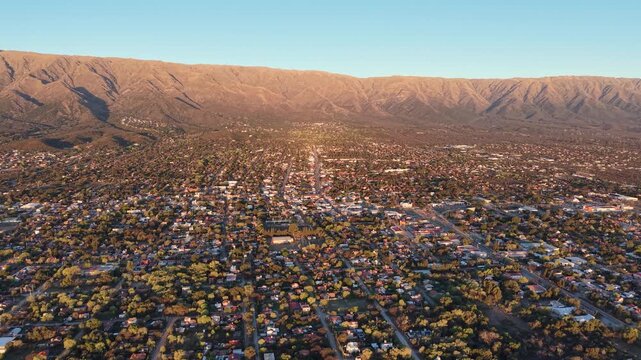 Wide angle aerial video showcasing Merlo city urban grid and natural landscape in San Luis