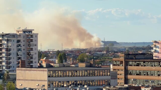 Thick Smoke Plume Rising Above City Buildings And Urban Residential. Air Pollution. Environmental Hazard 