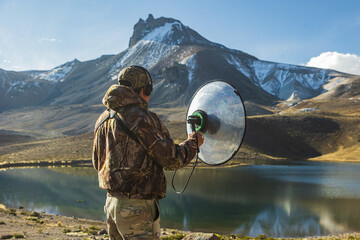 Fototapeta premium Person observing and recording birds in the Peruvian Andes.