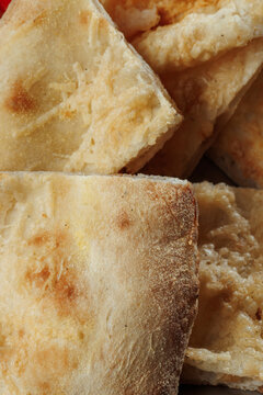 Macro Photography of Golden Italian Flatbread with Crispy Baked Crust, Melted Cheese and Rustic Artisan Texture
