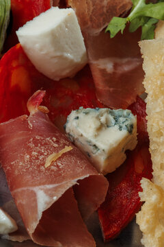 Macro View of Italian Flatbread with Golden Crispy Cheese Crust Served Alongside Prosciutto, Spicy Salami and Blue Cheese
