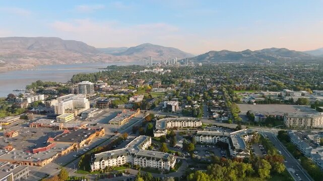 Aerial view on a clear, sunny day, of a non-descript, pleasant, small city or town by the water, with mountain in the background.
