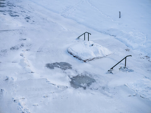 View of snow-covered stairs and metal railings in a winter landscape in Vilnius, Vilnius County, Lithuania.