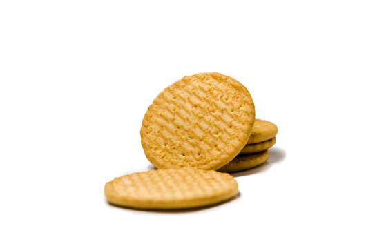 Stack of delicious golden baked biscuits and crackers isolated on white background
