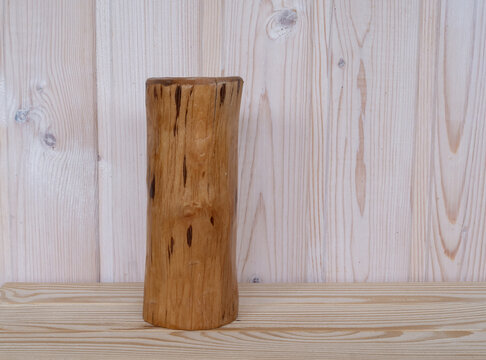 Rustic wooden candle holders handmade from natural logs displayed against light timber wall in home decor