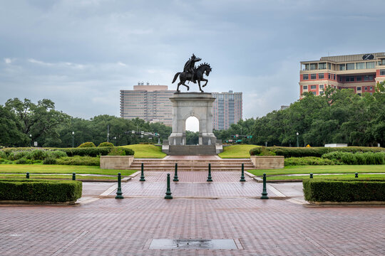 Equestrian statue of Sam Houston at Hermann Park, Houston, Texas. The bronze statue stands prominently on a stone pedestal amidst manicured greenery and paved walkways. 