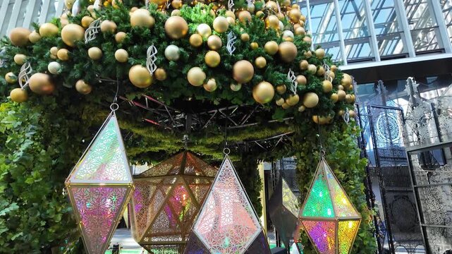Shinjuku City, Tokyo, Japan - 22 December 2023: View of the geometric, illuminated Christmas tree installation at the Shinjuku Sumitomo Building, featuring intricate metal patterns.