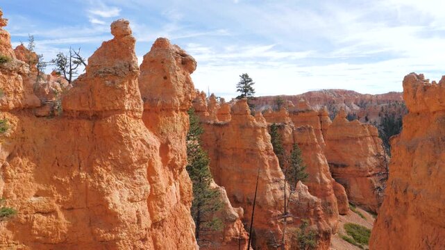 Amazing motion view of spectacular red sandstone hoodoos in bryce canyon national park utah. Revealing the scenic amphitheater of orange buttes and the forest below on a beautiful sunny day