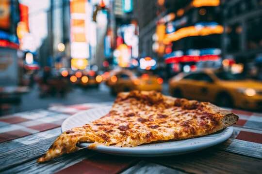 Classic New York style pizza slice with Times Square lights in background 