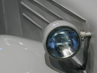 Detail of a headlight on a vintage car. © lapis2380