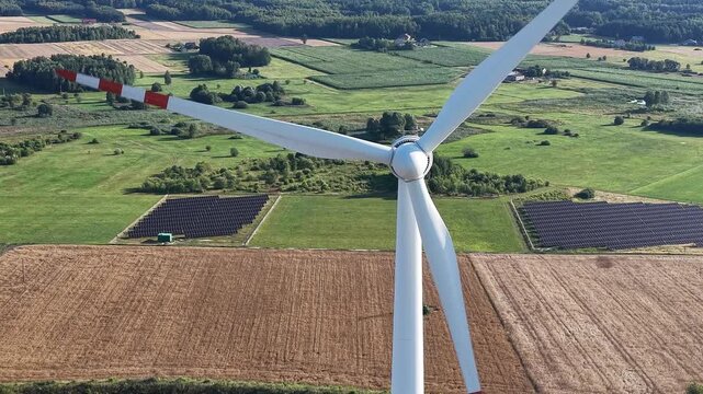 Hybrid solar panel farm and wind turbine plant from above