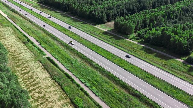 Multi lane highway surrounded by green forest and rural landscape