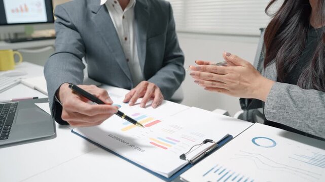 Business Team Reviewing Financial Charts in Meeting