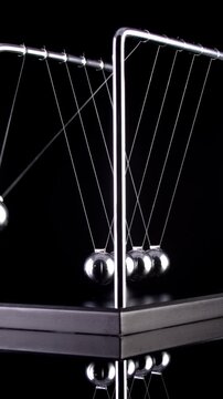 Newton's Cradle in slow motion. Vertical video.