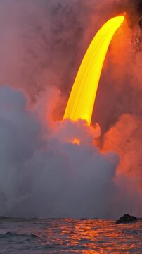 Lava from the Kilauea volcano flows into the ocean on the Big Island of Hawaii. Vertical Video.