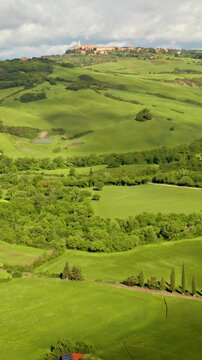 Flying over the beautiful rolling landscape of Tuscany Italy. Vertical video.