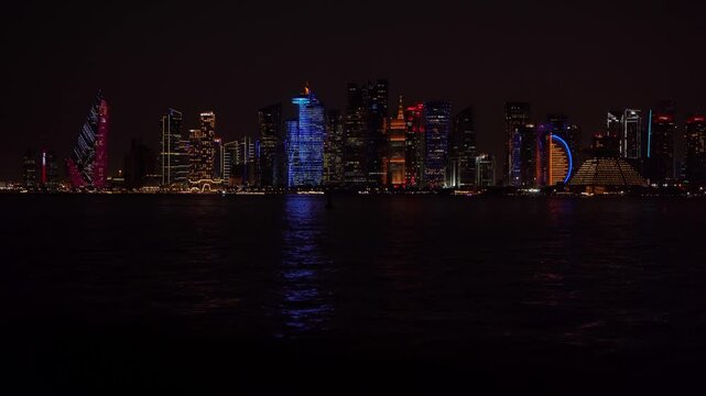 Doha, Qatar - 07 September 2026: View of the illuminated Doha skyline at night with skyscrapers reflecting on the calm waters of the Persian Gulf.