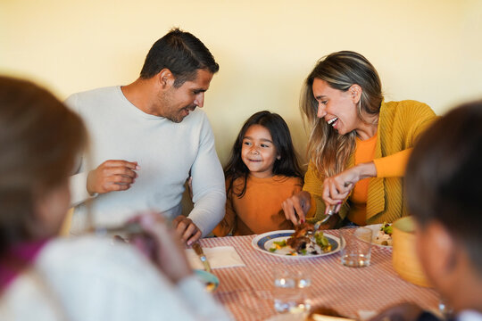 Happy multi generational family eating lunch together during autumn season - Latin american people, bonding and food concept