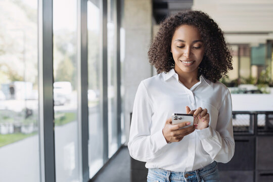 Business woman using smartphone in modern office, Student girl texting on mobile phone indoors, Communication, connection, mobile apps, technology, business lifestyle concept.