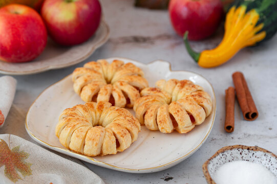 Baked apple pastries, cozy fall table close up